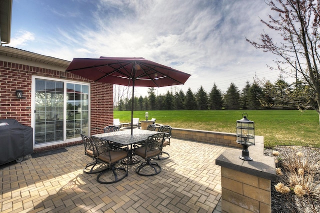 view of patio with outdoor dining area and grilling area