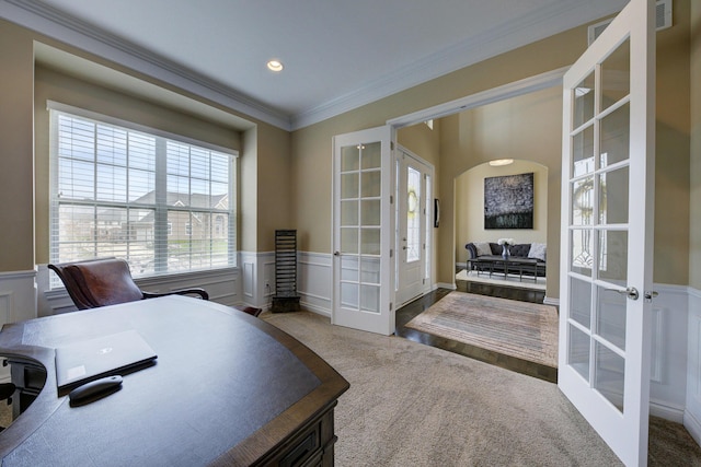 interior space with french doors, ornamental molding, carpet floors, and a wainscoted wall