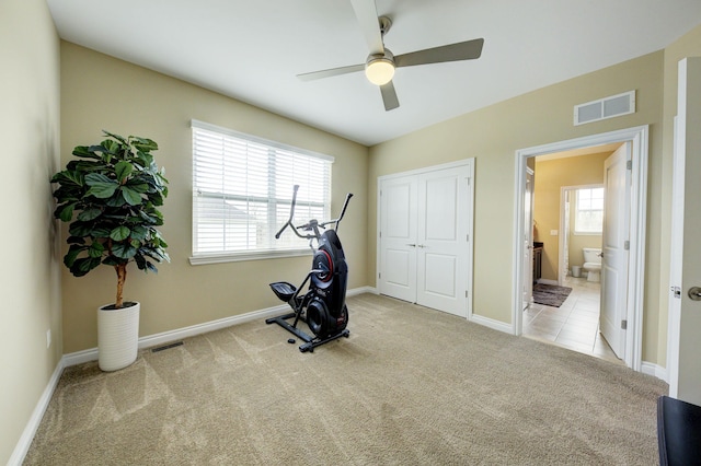 workout room featuring visible vents, a ceiling fan, carpet, and baseboards