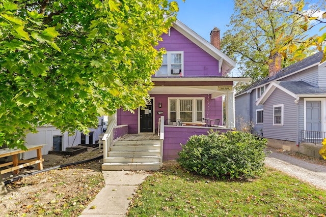 view of front of property featuring a porch and a chimney