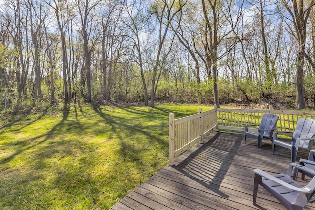 wooden terrace with a lawn