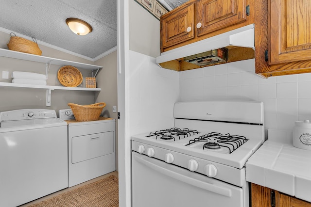 kitchen featuring open shelves, white gas range oven, light countertops, brown cabinetry, and under cabinet range hood