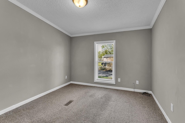 carpeted spare room with ornamental molding, a textured ceiling, and visible vents