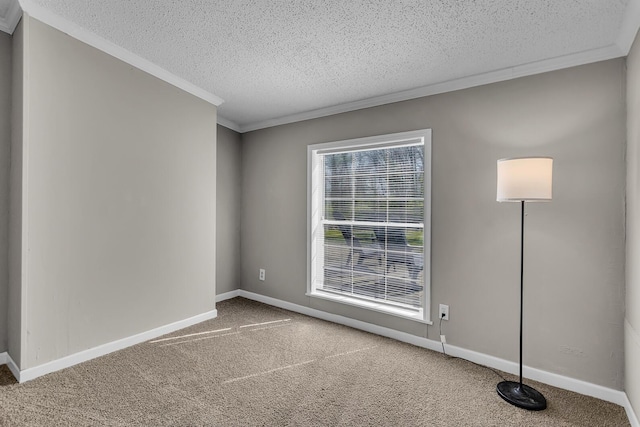 carpeted spare room with crown molding, a textured ceiling, and baseboards
