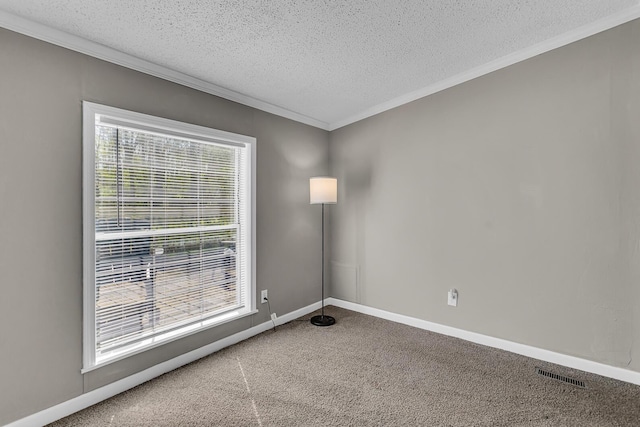 empty room featuring a textured ceiling, visible vents, carpet floors, baseboards, and ornamental molding