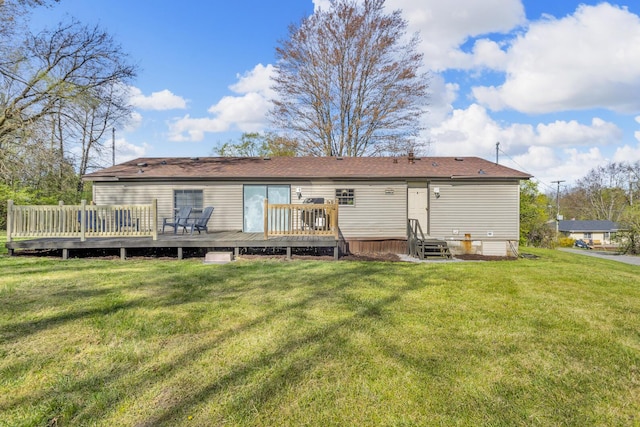 back of house featuring a lawn and a wooden deck