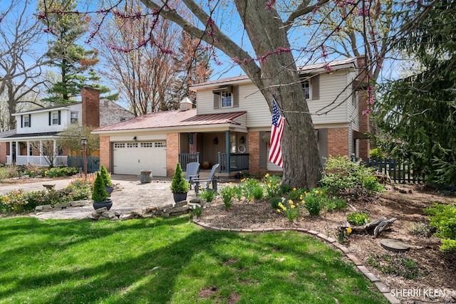 traditional-style house with driveway, a garage, brick siding, fence, and a front lawn