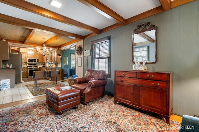 living area with beamed ceiling and a chandelier