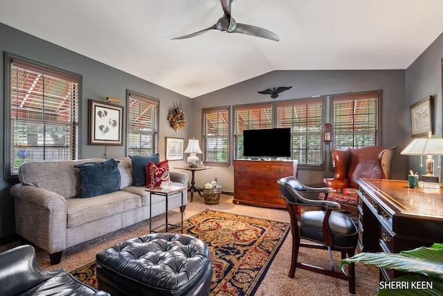 carpeted living area with a ceiling fan and vaulted ceiling