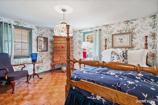 bedroom featuring wallpapered walls and baseboards