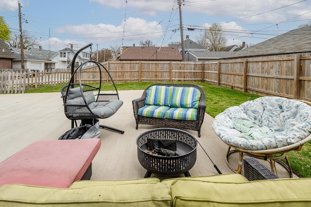 view of patio with a fenced backyard and an outdoor living space with a fire pit