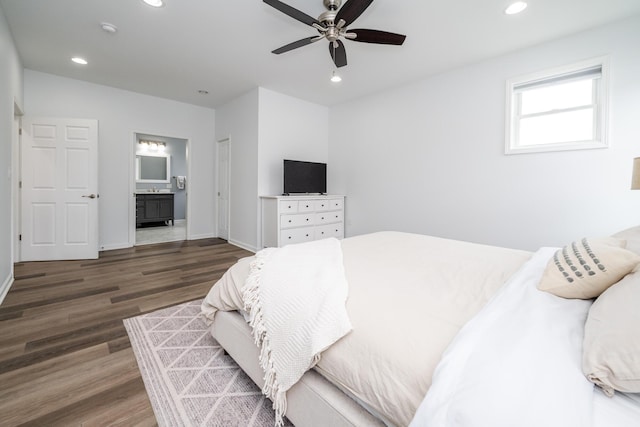 bedroom featuring ensuite bath, baseboards, recessed lighting, and wood finished floors