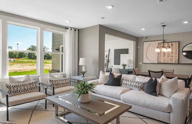 living area with recessed lighting and a notable chandelier