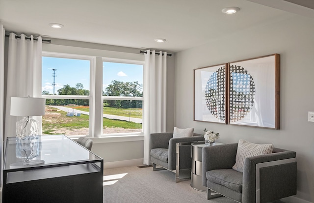 living area with light colored carpet, recessed lighting, and plenty of natural light