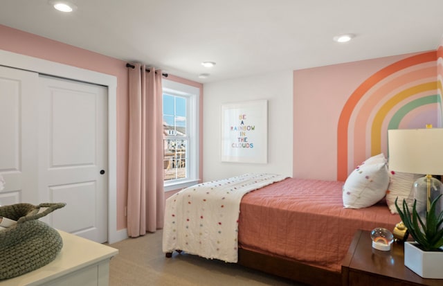 bedroom with light carpet, a closet, and recessed lighting