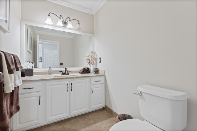 bathroom with tile patterned flooring, ornamental molding, vanity, toilet, and baseboards