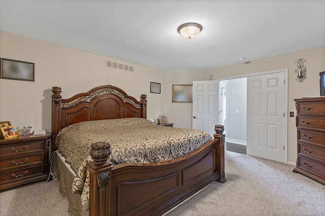 bedroom featuring light colored carpet and visible vents