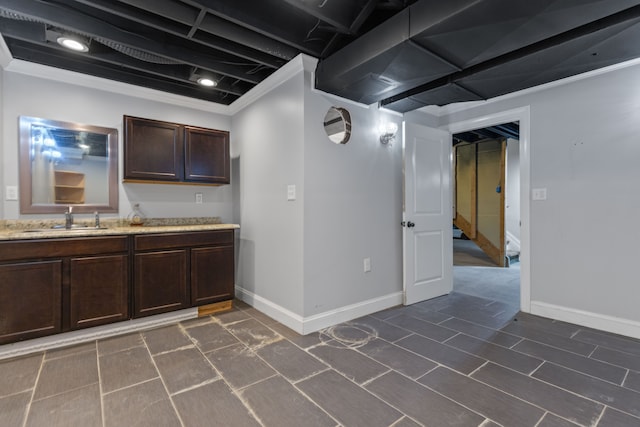 interior space featuring baseboards and a sink