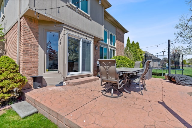 view of patio / terrace featuring outdoor dining area and a trampoline