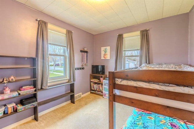 bedroom with baseboards, multiple windows, carpet flooring, and visible vents