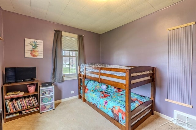 carpeted bedroom featuring baseboards