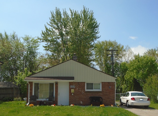 26575 Barnes St, Roseville, MI 48066 - view of front of home with brick siding and a chimney