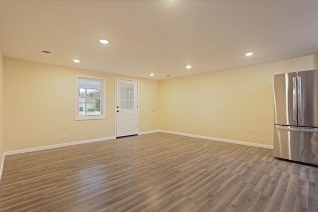 empty room with recessed lighting, baseboards, visible vents, and wood finished floors