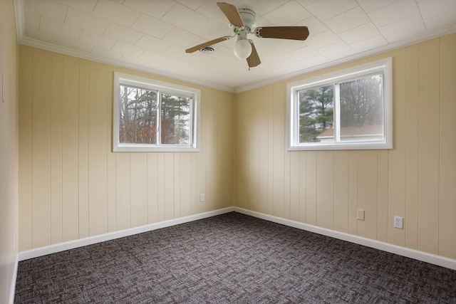 carpeted empty room with plenty of natural light and a ceiling fan