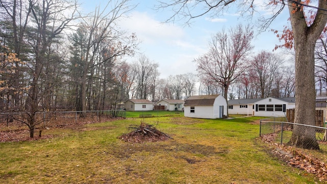 view of yard featuring a fenced backyard and an outbuilding