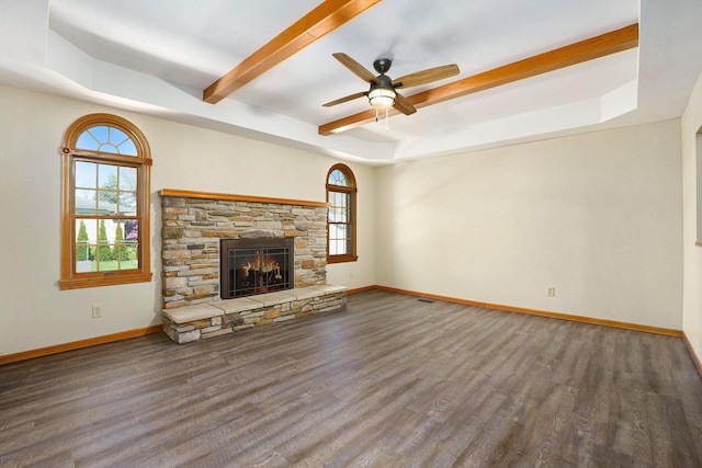 unfurnished living room featuring a wealth of natural light and wood finished floors