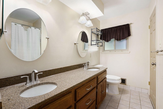 bathroom with a sink, tile patterned flooring, toilet, and visible vents