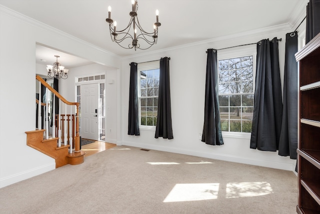entrance foyer featuring an inviting chandelier, crown molding, stairway, and plenty of natural light