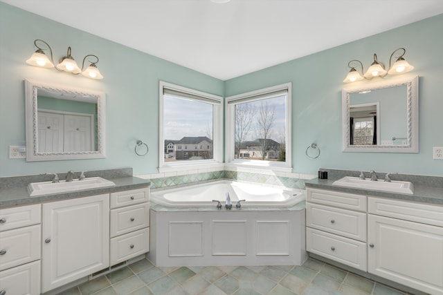 full bath with a sink, tile patterned flooring, and two vanities