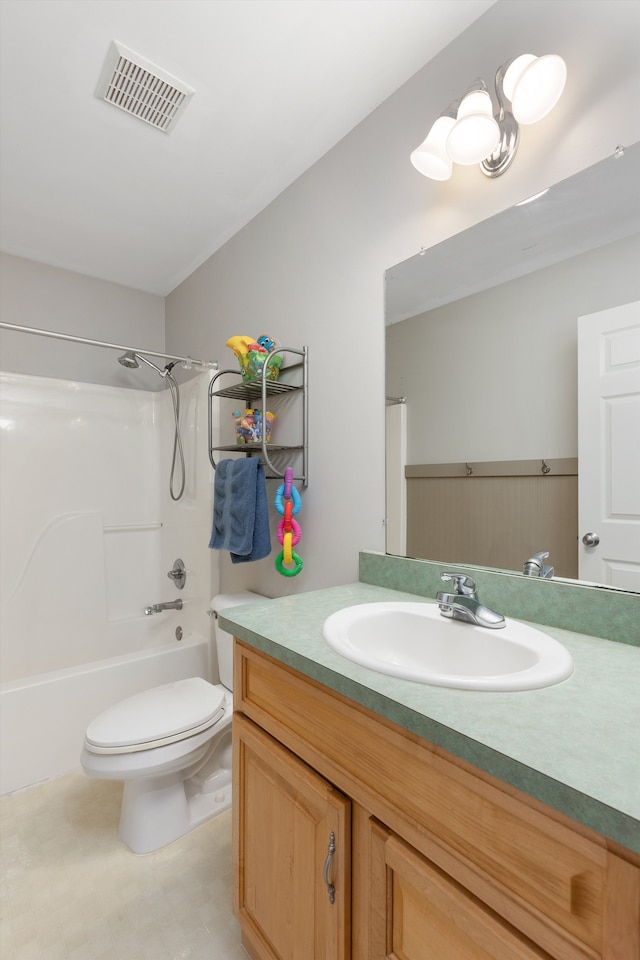 bathroom with tub / shower combination, vanity, toilet, and visible vents