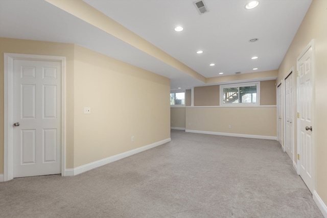 unfurnished room featuring light colored carpet, recessed lighting, and visible vents
