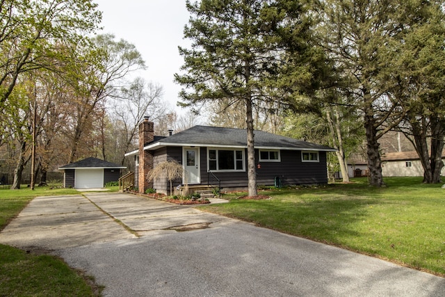 bungalow-style home with driveway, a chimney, an outdoor structure, and a front lawn
