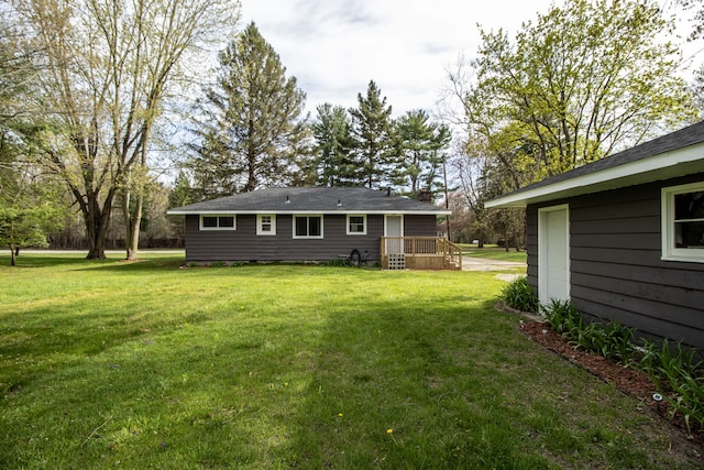 rear view of property featuring a yard