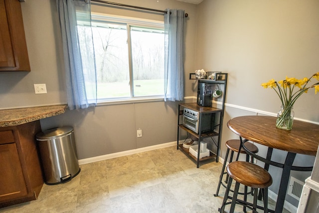 dining area featuring a healthy amount of sunlight and baseboards