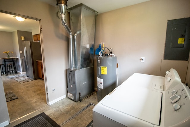clothes washing area featuring laundry area, baseboards, independent washer and dryer, electric panel, and water heater
