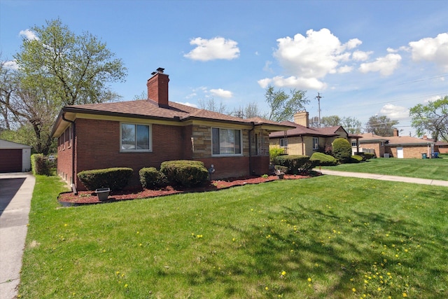 view of front of home featuring brick siding, a garage, a front yard, a chimney, and an outdoor structure