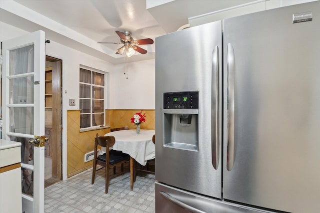 kitchen with ceiling fan, stainless steel fridge, and light floors