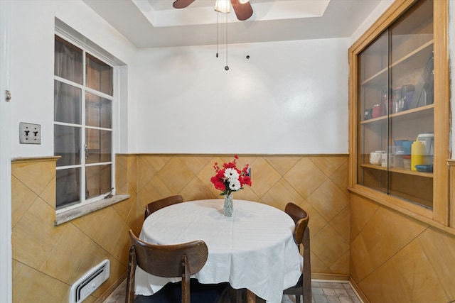dining room with a wainscoted wall and ceiling fan