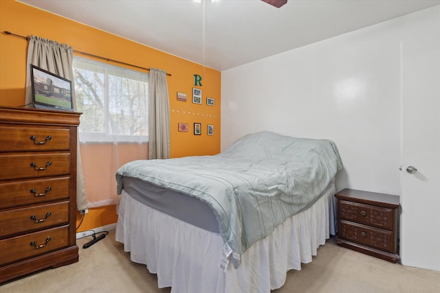 bedroom with ceiling fan and light carpet