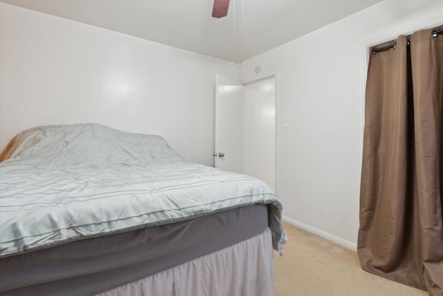 bedroom with baseboards, light colored carpet, and ceiling fan