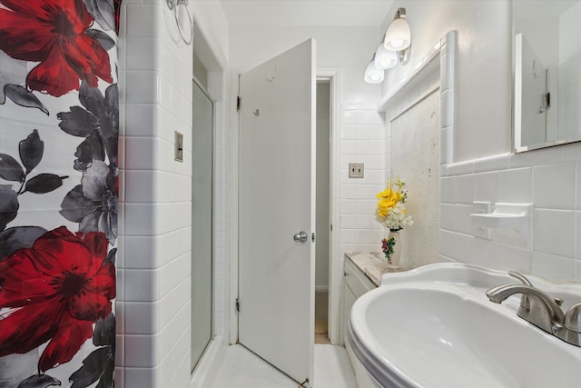 full bath with a sink and a shower stall