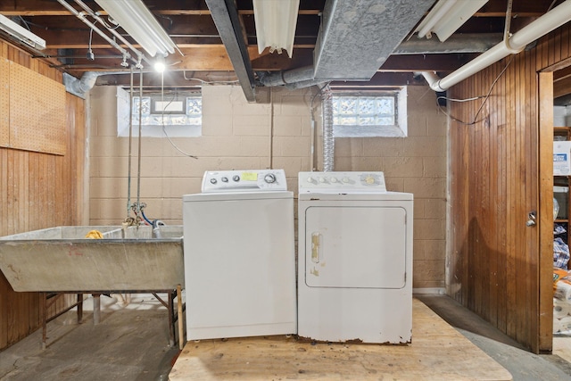 laundry room with laundry area, a sink, and washer and clothes dryer