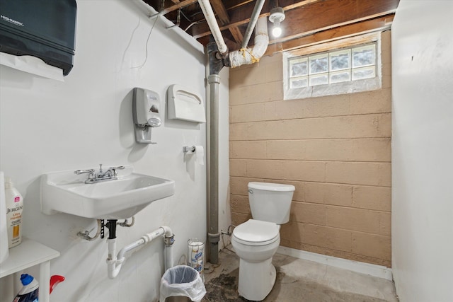 bathroom featuring concrete flooring and toilet