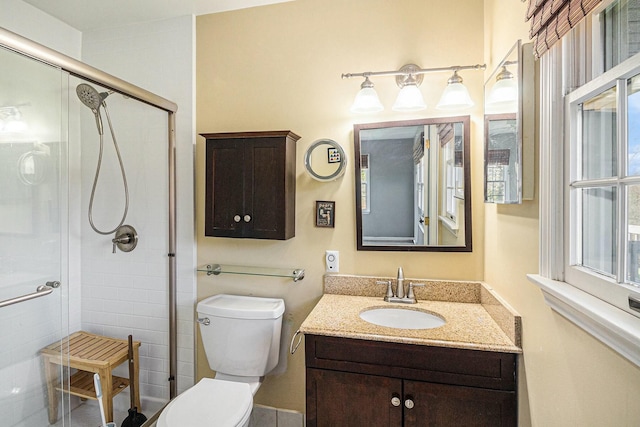 full bathroom with vanity, toilet, and a stall shower