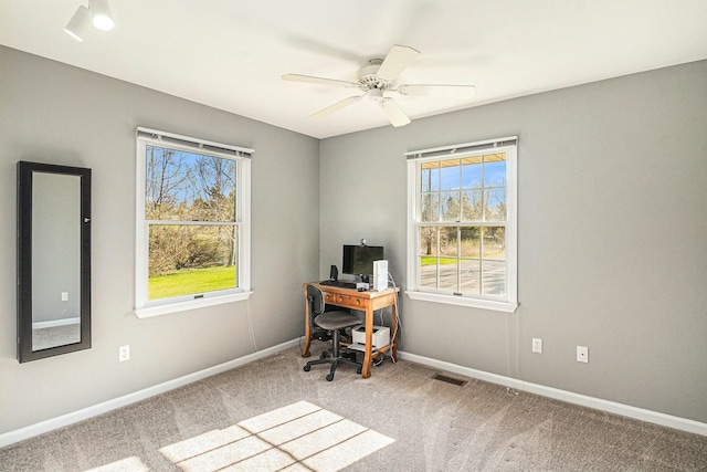 home office featuring baseboards, plenty of natural light, carpet flooring, and visible vents
