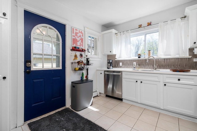 kitchen featuring a sink, white cabinets, stainless steel dishwasher, and a healthy amount of sunlight